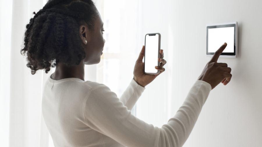 Woman pressing on smart home automation panel monitor